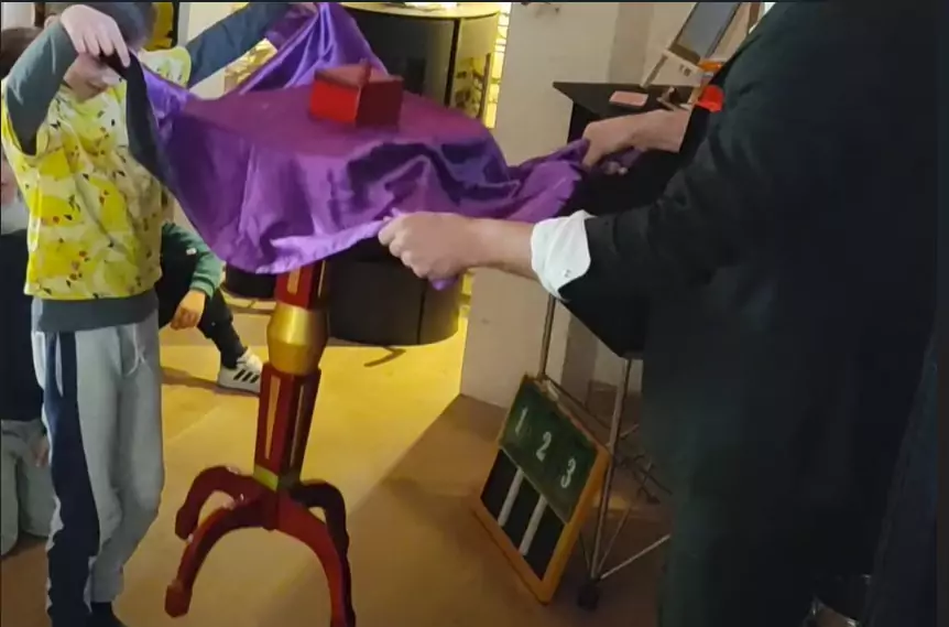 A magician floating a table in the air