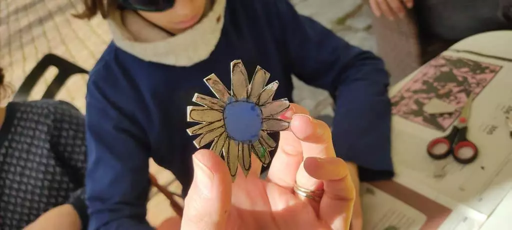 Workshop scene of kids making flowers out of cardboard